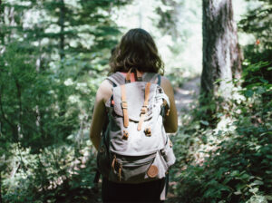 Photo fo person on a hike in teh woods